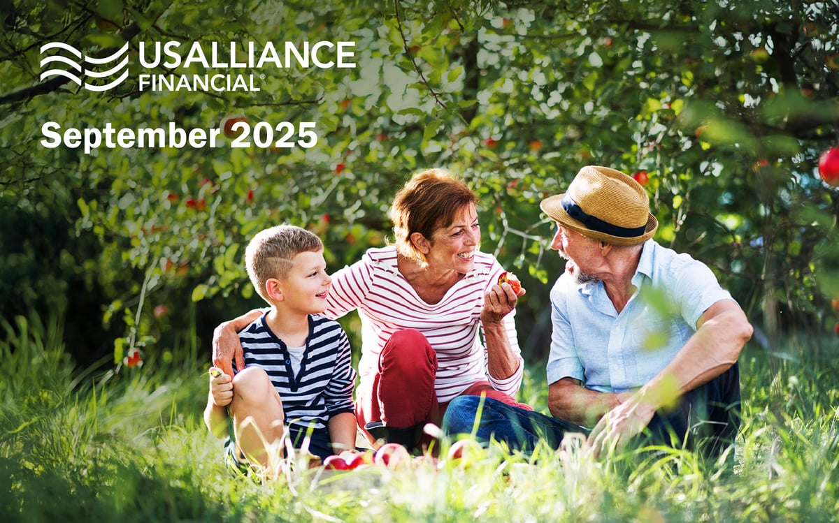 A family pick apples while smiling.