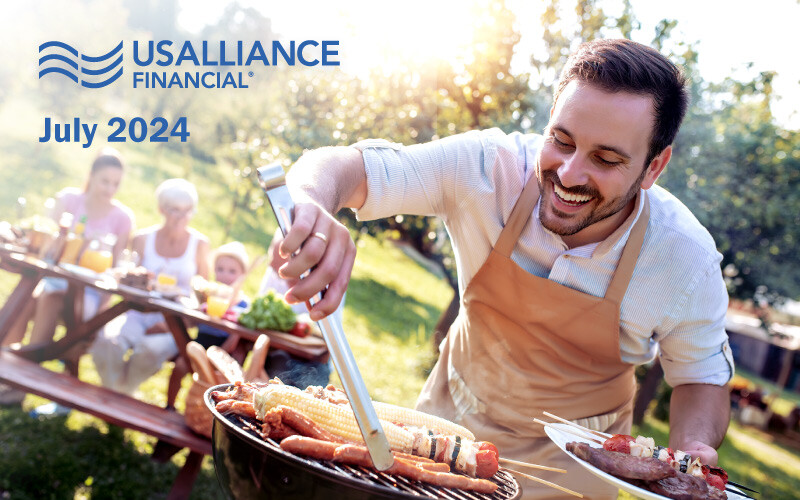 Man grilling food outdoors with people sitting at a picnic table in the background. Overlay text that reads, 